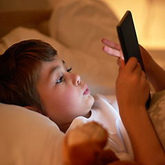 Image showing Boy, tablet and bed with night, learning and relaxing for social media or learning. Child, bedroom and connectivity for knowledge, youth and elearning or internet surfing at home with touchscreen