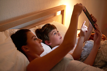 Image showing Mom, boy and tablet in bedroom at night for care, bonding and watch movies together in family house. Mother, child and home on digital touchscreen for cartoon, film and streaming subscription in bed