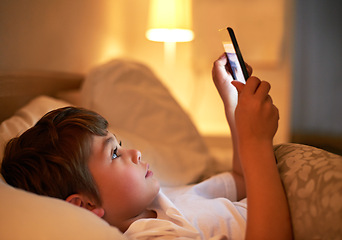Image showing Boy, tablet and bed with night, learning and technology for social media and growth. Child, bedroom and connectivity for knowledge, reading and elearning or internet surfing at home with touchscreen