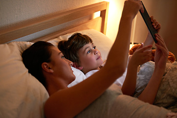 Image showing Mother, boy and tablet in bedroom at night for care, bonding or to watch movies together in family house. Mom, child and home on digital touchscreen for cartoon. film or streaming subscription in bed