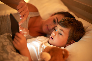 Image showing Mother, boy and tablet in bed at night for care, bonding or to watch movies together in family house. Mom, child and digital touchscreen for cartoon. film and streaming subscription in home bedroom