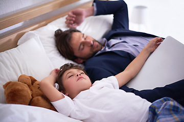 Image showing Businessman, sleeping and together with child in house for comfort, relax and pyjamas to dream in bedroom. Tired, peace and dad with son on bed, cute and sweet moment for parent after work in home