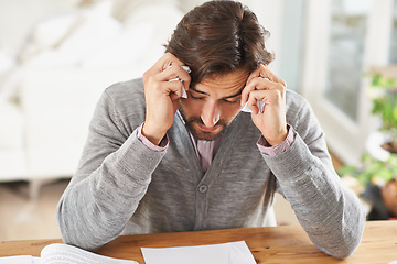 Image showing Writer, man and stress in home office with paper on desk, headache and worried to meet deadline. Author, procrastination and frustrated with work on research for information, writing tips for story