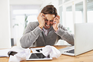 Image showing Man, laptop and frustrated at home office with paper on desk, overtime and stress to meet deadline. Startup, home, and headache with research on information for growth with tablet and business notes