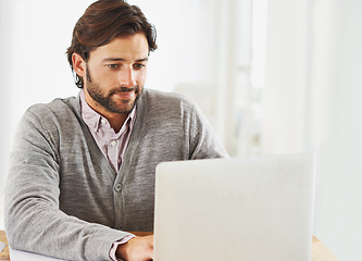 Image showing Journalist, laptop and typing in home office on desk with online, research and information for news. Freelance, remote work and man writer in table for publication with update, report and article