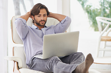 Image showing Businessman, relax and couch with laptop online for remote work, living room and home office for freelance job. Male person, social media and browsing or research on computer, sofa and smile