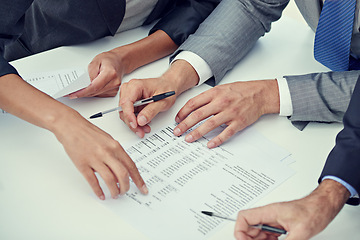 Image showing Closeup, hands and business people with paperwork, finance or contract for b2b deal or economy. Brokers, manager or employee with documents or trading with stats or signing with planning or writing