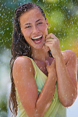 Image showing Woman, rain and portrait with laughing from summer climate, water and weather outdoor in park. Happy, travel and female person with funny joke from raindrops on holiday and vacation with trip and joy