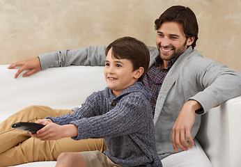 Image showing Relax, TV and father and child on sofa with remote for bonding, smile and fun in living room. Family, parents and dad with young son for cartoon, watching movies and entertainment in home