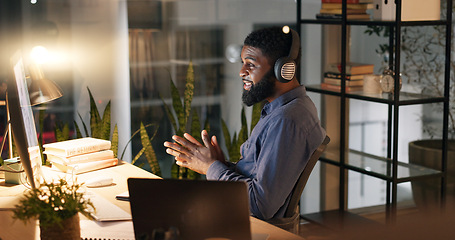 Image showing Night, business and video call with black man, office and professional with communication, headphones and computer. Employee, entrepreneur and PR consultant with pc or talking with online meeting