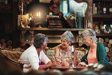 Image showing Relax, wine and laugh with elderly friends in home for bonding, funny and smile. Retirement, diversity and happiness with group of senior female people with drink for social, memory and support