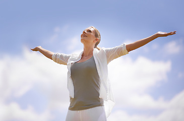 Image showing Happy woman, meditation and freedom with blue sky background for spiritual wellness, faith or hope in nature. Calm female person with smile and open arms for fresh air, health and outdoor wellness