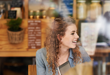 Image showing Coffee shop, relax and woman in window with laptop for internet, social networking and website. Happy, smile and person on computer in restaurant, cafe and diner for caffeine, beverage and cappuccino