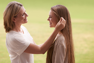 Image showing Happy, mother and daughter touching hair for love, care and proud family for support. Woman, smiling and outdoors for healthy relationship, parent and mom with teenage daughter in nature park