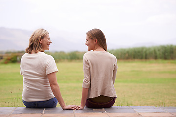 Image showing Women, mother and daughter with garden, back and conversation in morning with bonding, love and care. People, girl and family for talking, chat or relax together on patio by grass lawn in countryside