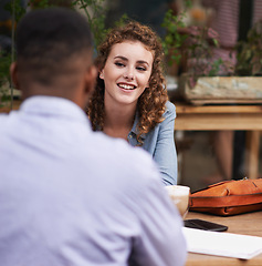 Image showing Interracial couple, smile and date at restaurant, cafe and coffee shop for conversation. Happy woman, man and relax at cafeteria for communication, connection and bonding together for relationship