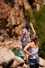Image showing Rock climbing, view and friends with route planning and pointing for adventure and outdoor exercise. Mountain, sport and training in nature with people on a peak for a workout together for fitness