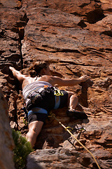 Image showing Woman, back and rock climbing for fitness in outdoors, challenge and rope for training. Female person, cliff and extreme sport for exercise or workout, low angle and support to explore in nature