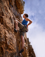 Image showing Rock climbing, woman and fitness with adventure, rope and gear in nature on a mountain. Cliff, hiking and sport with athlete challenge and thinking for workout, exercise and climber training outdoor