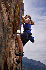 Image showing Woman, hiking and rock climbing for workout in outdoors, challenge and rope for training. Female person, cliff and extreme sport for exercise or fitness, mountain and support to explore in nature