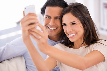 Image showing Happy couple, sofa and selfie in relax for photography, picture or bonding memory together in living room at home. Young man or woman with smile for photo, vlog or social media on couch at house