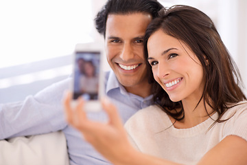 Image showing Happy couple, relax and selfie on sofa for bonding, photography or picture in living room together at home. Young man or woman with smile for photo vlog, picture or social media on couch at house