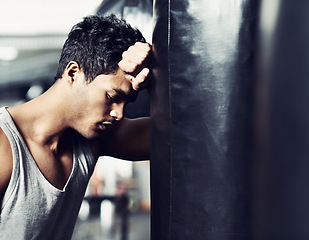 Image showing Fitness, punching bag or tired man at gym with low energy, loss or performance fail or mistake. Sports, fatigue or male boxer exhausted by intense body workout, challenge or fighting practice burnout