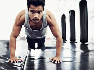 Image showing Male person, pushups and training for fitness, sport and health for being a boxer on mat for muscles. Man, wellness and exercise for workout, athlete and cardio strength for commitment in boxing gym