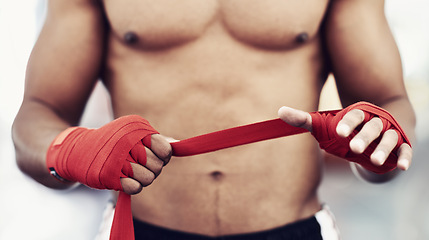 Image showing Closeup, man and wrap of hand for fight, martial arts and boxing at fitness and workout studio. Strap, boxer and gym to exercise, practice and training for health, energy and strength for protection