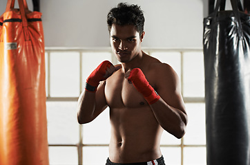 Image showing Portrait, man and boxing in club for sports, training and workout for healthy body. Fighter, face and serious athlete with muscle on abs for fitness, exercise and martial arts at a gym in Brazil