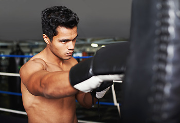 Image showing Sports, serious and man boxer in gym for exercise, workout and combat training for competition. Cardio, health and shirtless male athlete fighter in boxing ring with gloves in fitness center.