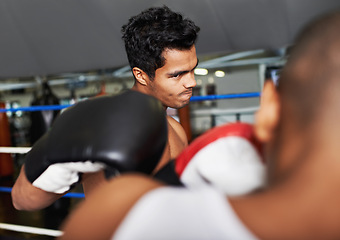 Image showing Boxer, man and fight in boxing ring for training, workout and confidence for performance with coach and fitness. Professional, athlete and exercise for competition, match and sport with endurance