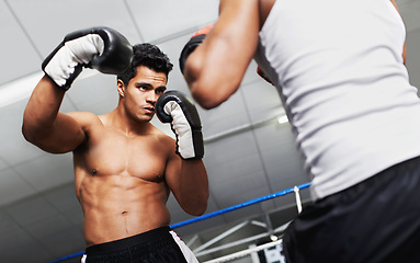 Image showing Boxer, man and fight in boxing ring for practice, training or confidence for performance with coach or fitness. Professional, athlete or exercise for competition, match or sport with personal trainer