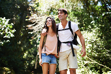 Image showing Hiking, happy and couple in nature walking for adventure, freedom and explore together outdoors. Dating, travel and man and woman on mountain for holiday, vacation and trekking for wellness in forest