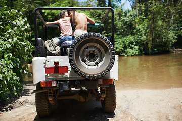 Image showing Couple, forest and adventure with 4x4, drive and outdoor with love, care or nature with river in summer. People, man and woman with back in vehicle, car or journey on road trip in jungle in Colombia