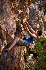 Image showing Rock climbing, woman and fitness with rope, travel and gear to explore in nature on a mountain. Cliff, hiking and sport with athlete and adventure for workout, exercise and climber training outdoor