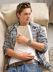 Image showing Living room, man and sleep on sofa with book for reading, break and tired at home with fatigue. House, nap and exhausted on couch to rest with dreams for wellness, stress relief, self care and relax