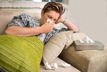 Image showing Virus, influenza or man sneezing into tissue on sofa with cold, bug or hay fever at home. Flu, allergies or person with toilet paper for viral infection, bacteria or coughing with sinusitis in house