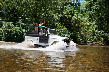 Image showing Couple, forest and adventure with 4x4, river and outdoor with love, care or nature with drive in summer. People, man and woman for splash in vehicle, car or journey on road trip in jungle in Colombia