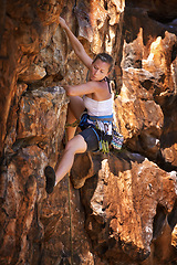 Image showing Woman, mountain and rock climbing for exercise in outdoors, challenge and rope for training. Female person, cliff and extreme sport for fitness or workout, hiking and support to explore in nature