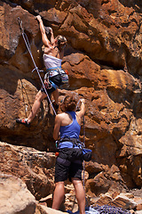 Image showing Rock climbing, cardio and friends with route planning and pointing for adventure and outdoor exercise. Mountain, sport and training in nature with people on a peak for a workout together for fitness