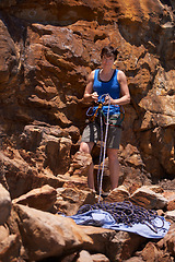 Image showing Woman, rope and rock climbing with gear, portrait and sport outdoor in the mountain. Training, exercise and workout equipment with hiking, backpack and travel with climber group and friends together