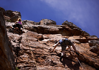 Image showing Hikers, rock climbing and outdoors for adventure, fitness and exercise in the sun for extreme sports. People, climb wall and nature for wellness, mountain and fearless activity for strength