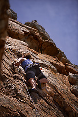 Image showing Mountain, fitness and woman rock climbing in nature for wellness, freedom or training. Balance, cliff or below lady athlete with adrenaline, sport or energy for workout, challenge or body performance