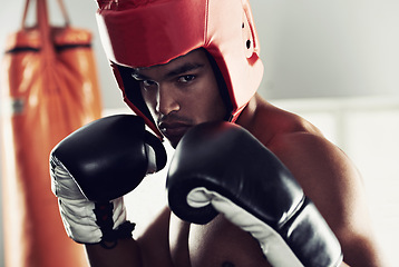 Image showing Sports, portrait and man boxer in gym for exercise, workout and combat training for competition. Breathing, health and shirtless male athlete fighter in boxing ring with gloves in fitness center.