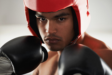 Image showing Fitness, cardio and man boxer in gym for exercise, workout and combat training for competition. Breathing, health and shirtless male athlete fighter in boxing ring with gloves in sports center.