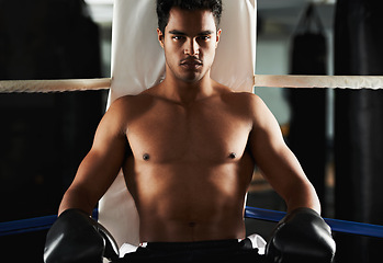 Image showing Portrait, man and boxing ring for sports, training and workout at corner of gym for body health. Fighter, serious face and athlete with gloves for fitness, exercise or strong abs at club in Brazil