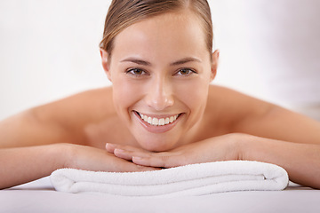 Image showing Spa, massage and portrait of woman on bed with smile for luxury, treatment and pamper with peace in hotel. Female person, happy and body care at resort for wellness, enjoyment and rest on vacation