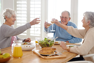 Image showing Wine, cheers and senior friends at lunch in home with smile, celebration and bonding in retirement. Food, drinks and toast with glass, old man and women at dinner table together for happy brunch.