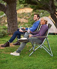 Image showing Camping, men and friends with drinks for relax on grass in nature with happiness for holiday and vacation. People, smile and alcohol at campsite in woods for adventure, travel and bonding in forest